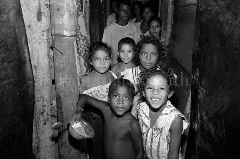 Displaced families in a narrow corridor of a shelter